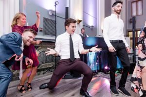 Young adults dancing at wedding reception